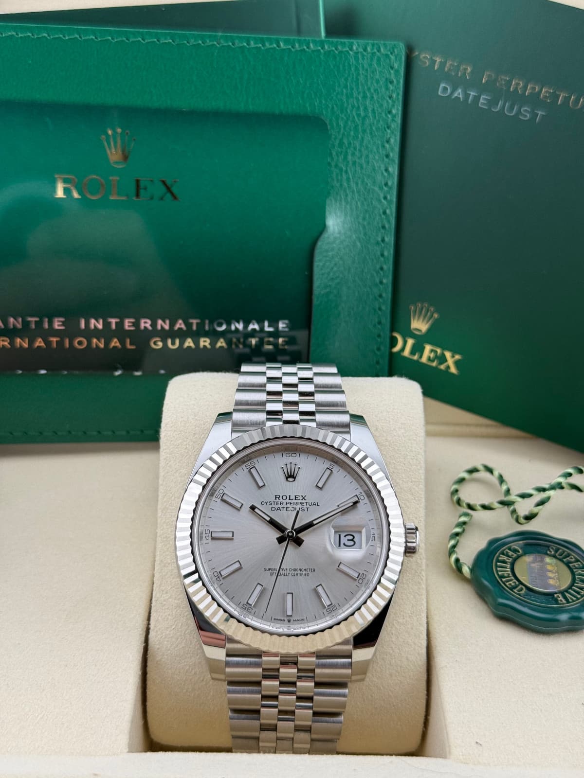 Rolex Datejust 41 Silver Jubilee 126334 Rolex watch in a box with green Rolex packaging in the background