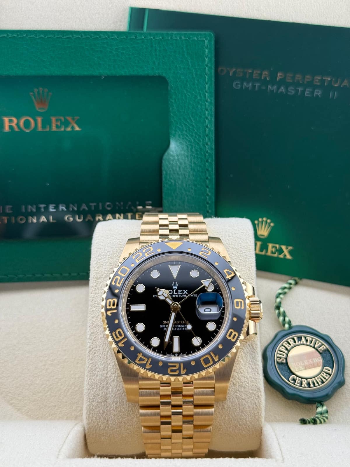 Rolex GMT-Master Yellow Gold 126718GRNR - Gold and blue Rolex watch with green box and papers in the background