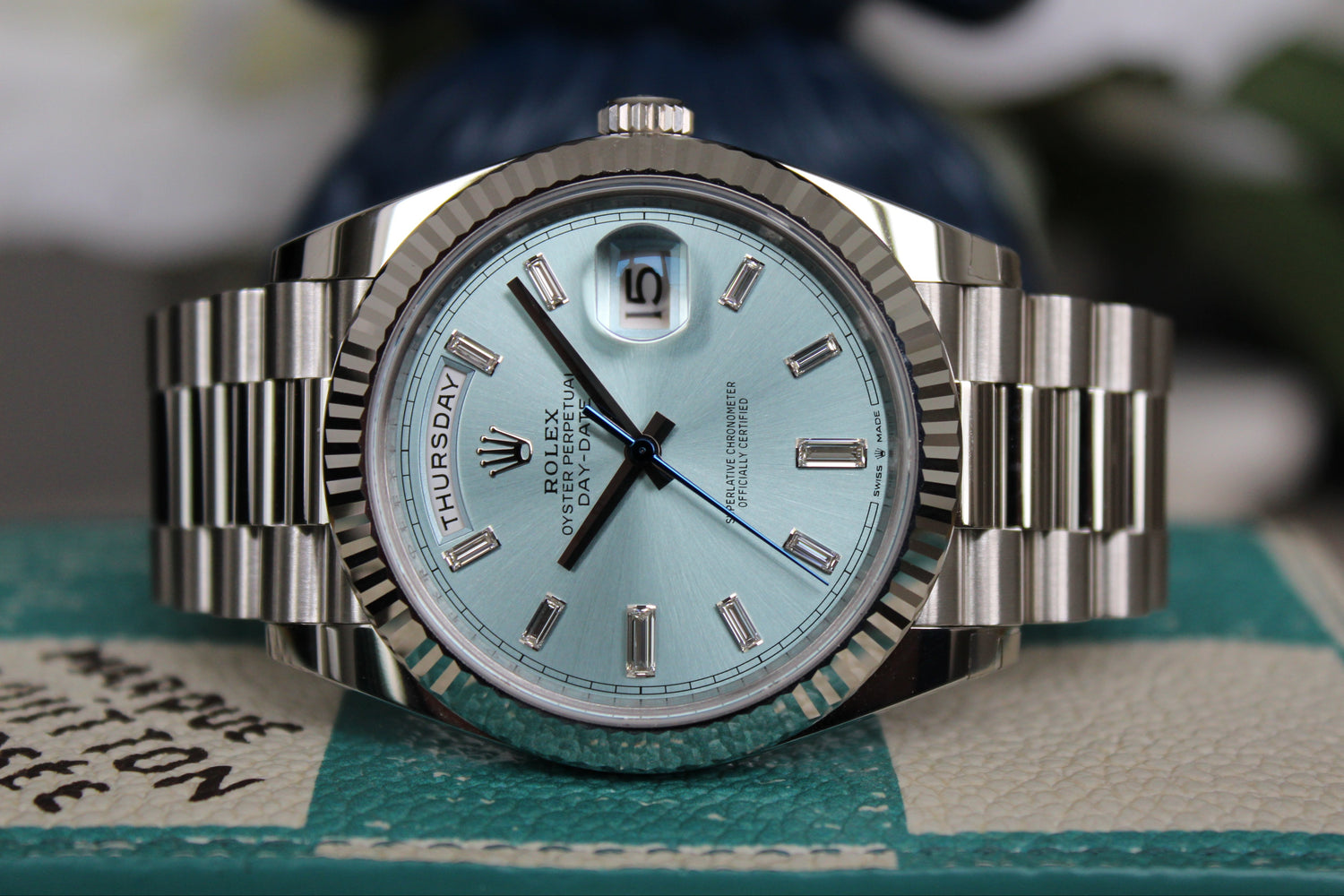 Rolex Day-Date 40 watch with ice blue baguette dial in Platinum reference 228236