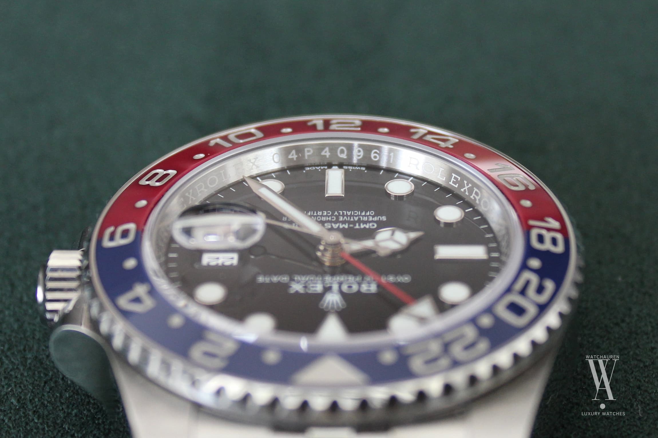 Close-up of a Rolex GMT-Master II "Pepsi" dial showing the engraved serial number on the rehaut.